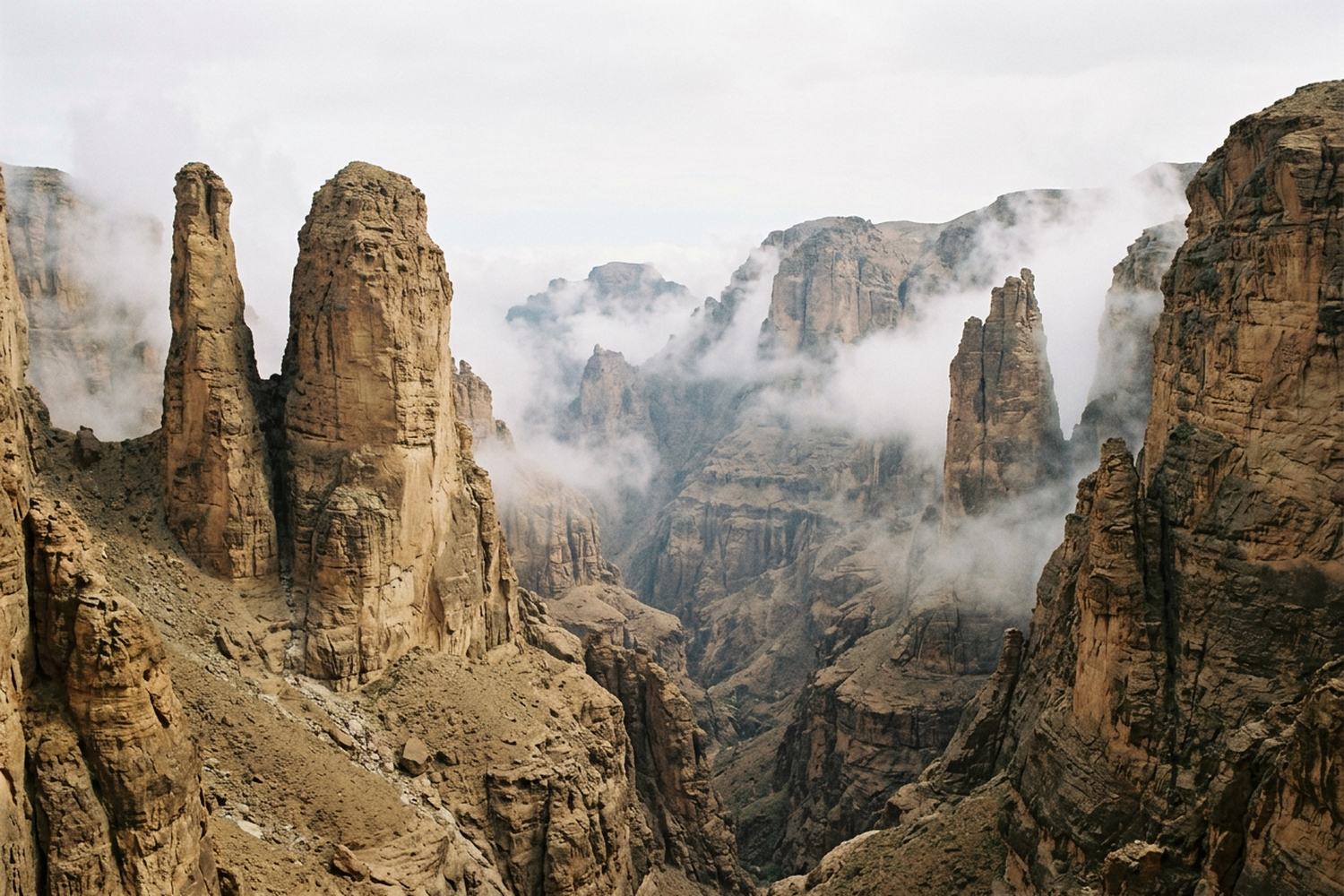 Sandstone towers rising out of a deep wooded gorge.